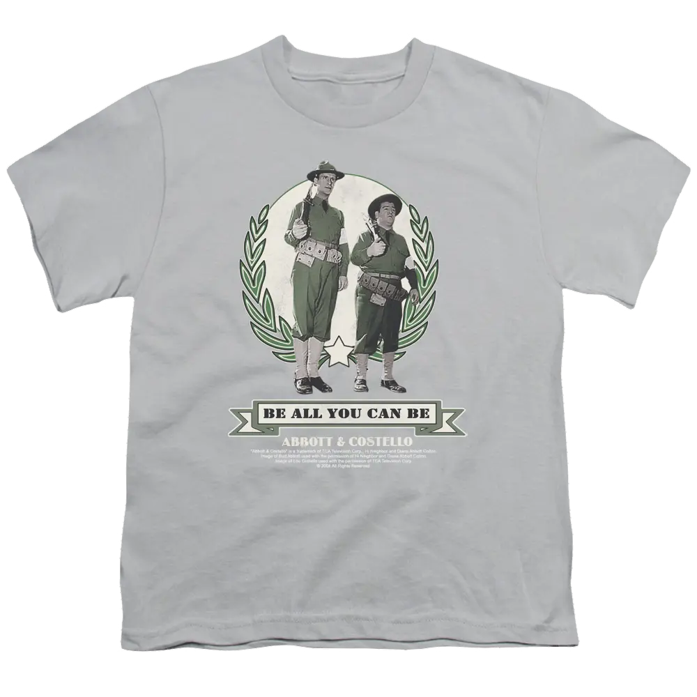 Youth silver T-shirt featuring Abbott and Costello vintage duo in green laurel wreath with "Be All You Can Be" text.