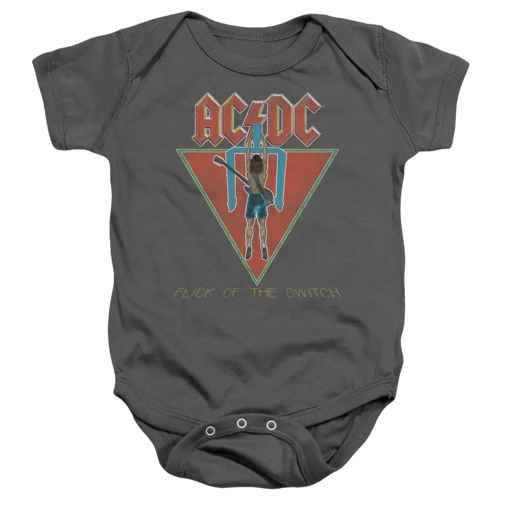 Charcoal baby bodysuit with AC/DC Flick Of The Switch album cover graphic in red and yellow tones.