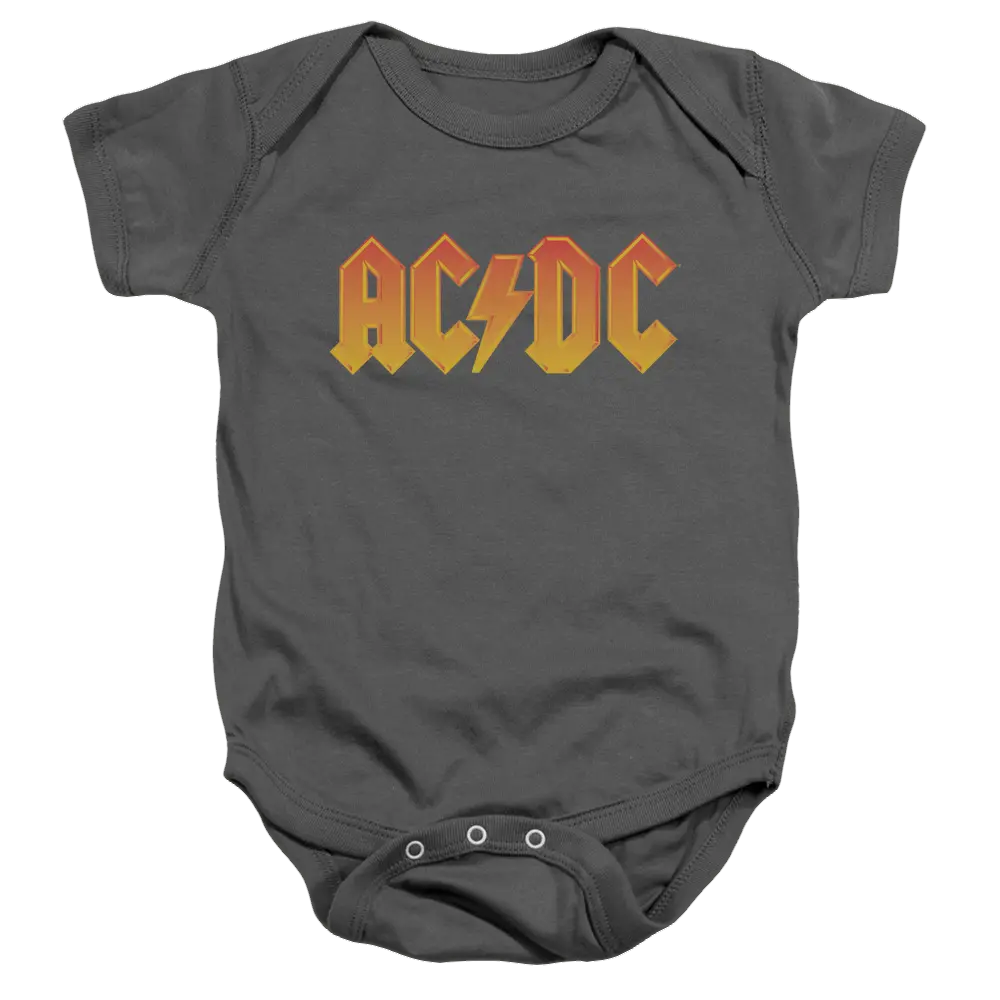 Charcoal baby bodysuit with orange and yellow AC/DC logo across chest and snap closures at bottom.